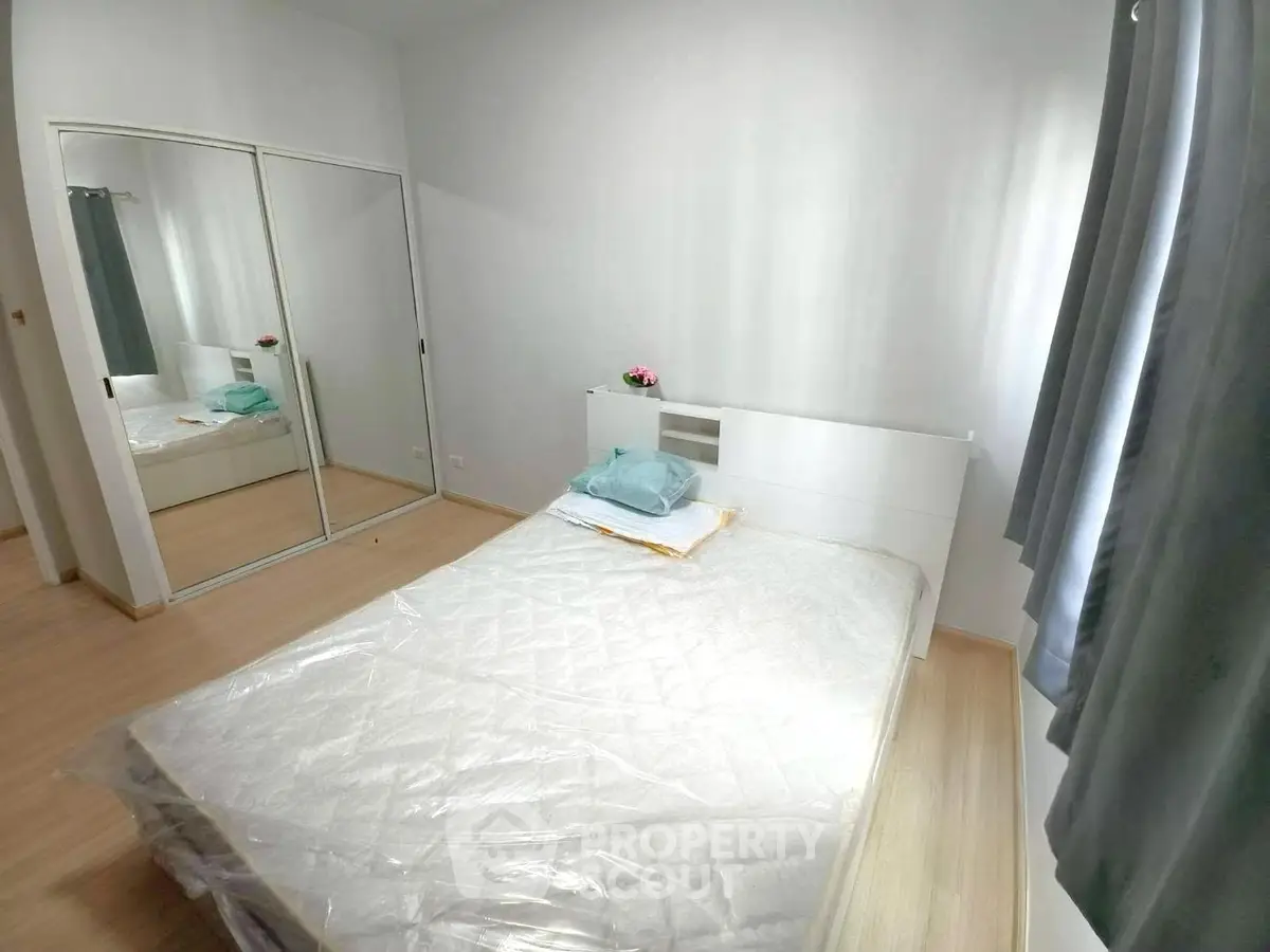 Bright and cozy bedroom with mirrored closet and natural light
