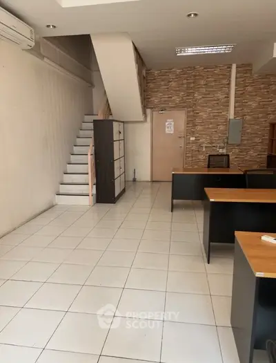 Spacious office interior with modern design and staircase