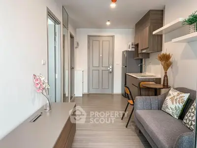 Modern apartment interior with cozy living area and compact kitchen design.