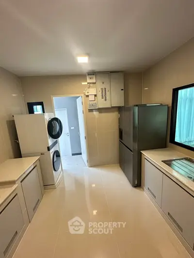 Modern kitchen with sleek appliances and ample storage space