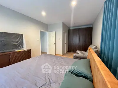 Spacious bedroom with modern furnishings and ample natural light