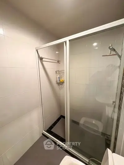 Modern bathroom with glass shower enclosure and sleek tile design