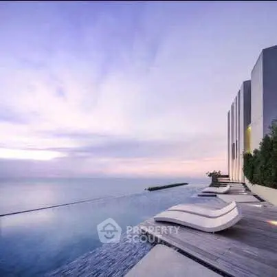 Luxurious rooftop infinity pool with stunning ocean view at sunset, perfect for relaxation and leisure.