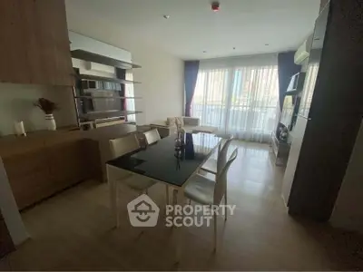 Modern living room with dining area and large windows in a stylish apartment