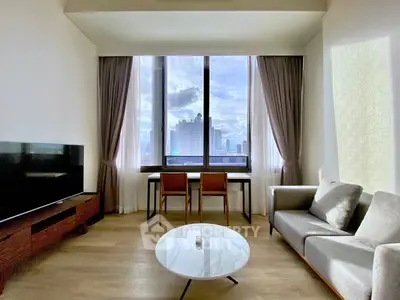 Modern living room with city view, sleek furniture, and large window for natural light.