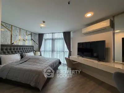 Luxurious modern bedroom with stylish decor and large TV