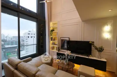Luxurious living room with city view, elegant decor, and modern furnishings in high-rise apartment.