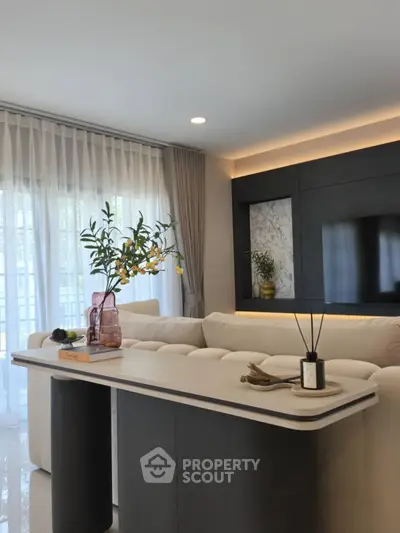 Modern living room with elegant decor, featuring a plush sofa, stylish table, and ambient lighting.