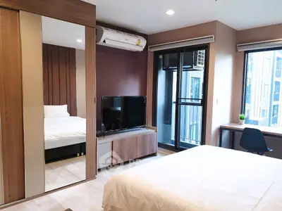 Modern bedroom with balcony access and stylish decor in urban apartment