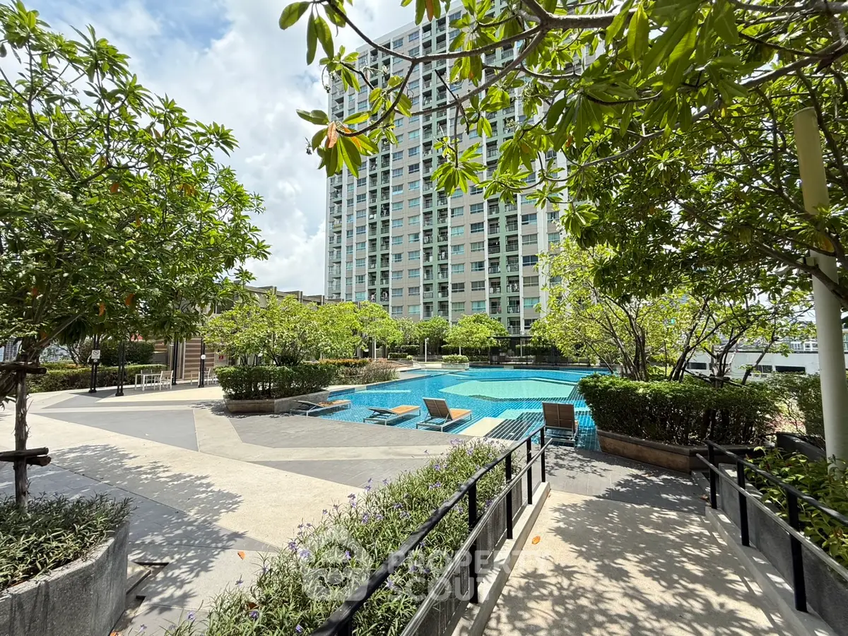 Luxurious condominium with serene pool and lush greenery, perfect for relaxation and leisure.