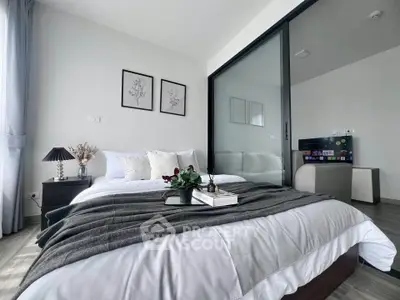 Modern bedroom with stylish decor and cozy ambiance, featuring a comfortable bed and elegant furnishings.