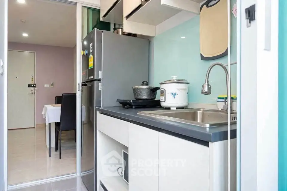 Modern compact kitchen with sleek appliances and dining area view