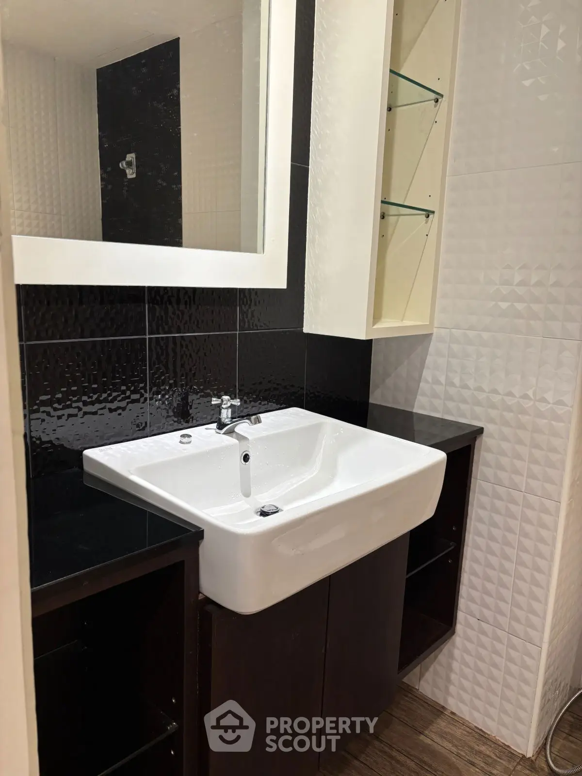 Modern bathroom with sleek sink and stylish black and white tiles