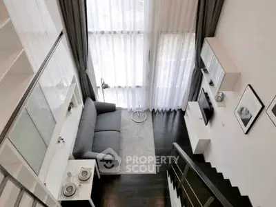 Modern loft-style living room with high ceilings and elegant decor