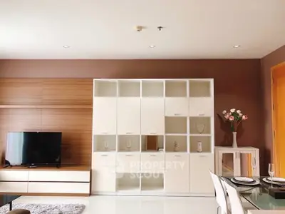 Modern living room with stylish shelving and flat-screen TV