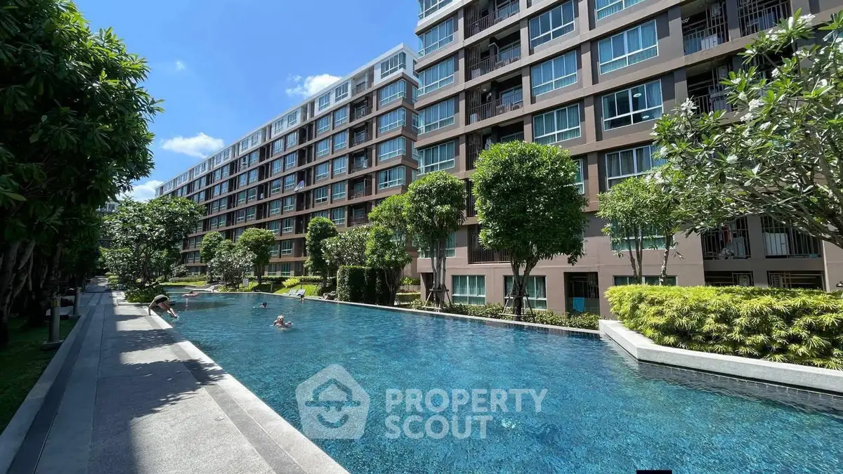 Luxurious condominium with a stunning outdoor pool and lush greenery, perfect for relaxation and leisure.