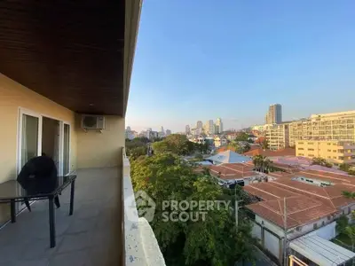 Spacious balcony with stunning cityscape view, perfect for relaxing and entertaining.