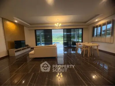 Spacious living room with elegant decor and stunning outdoor view, perfect for modern living.