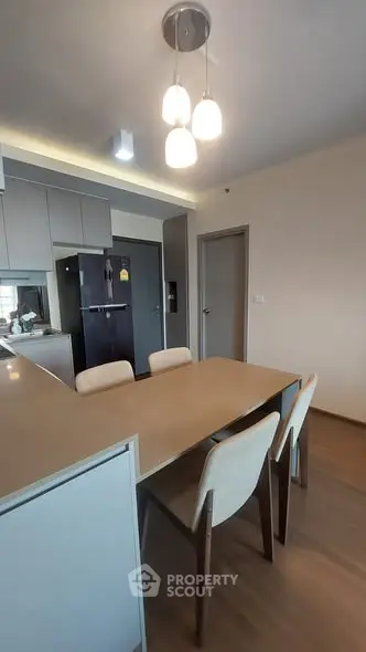 Modern kitchen with sleek dining area and contemporary lighting