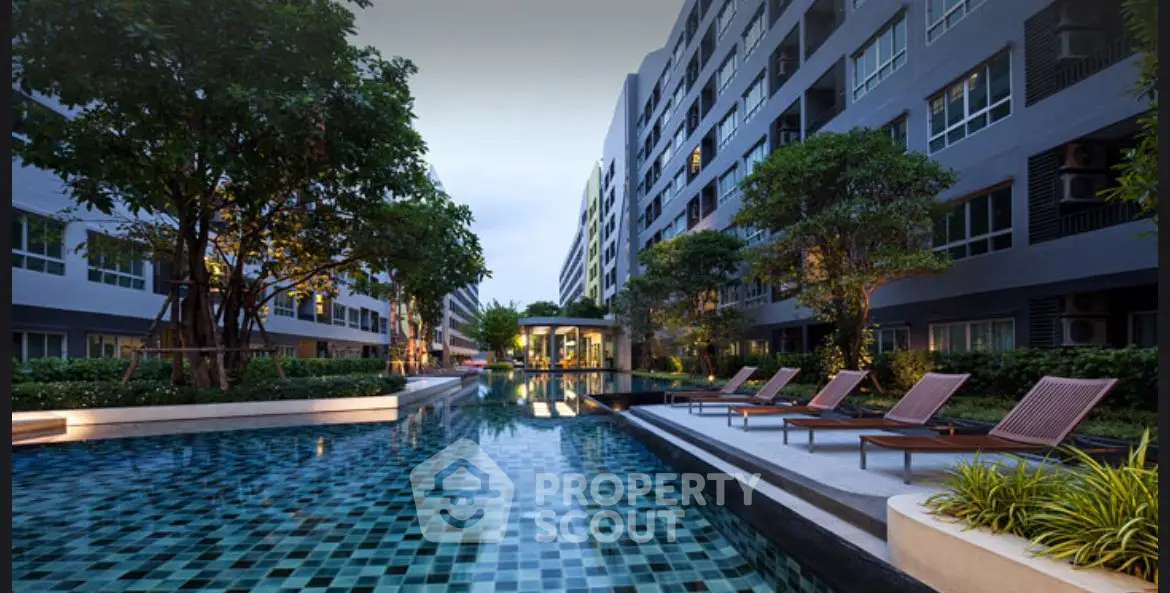 Luxurious apartment complex with stunning pool and lush greenery