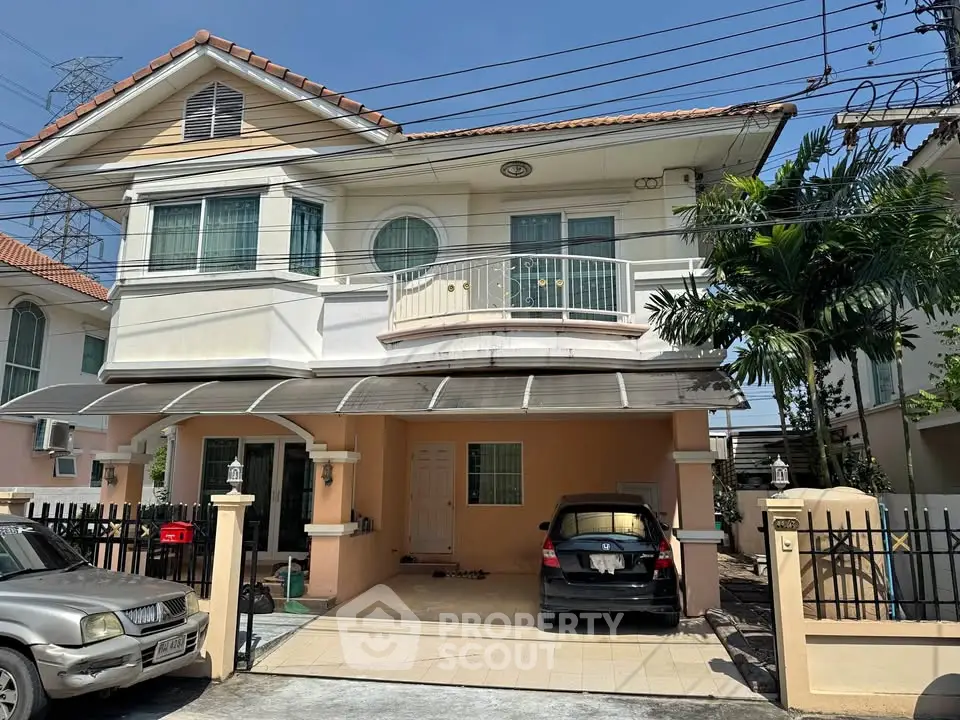 Charming two-story house with carport and balcony in a suburban neighborhood, perfect for family living.