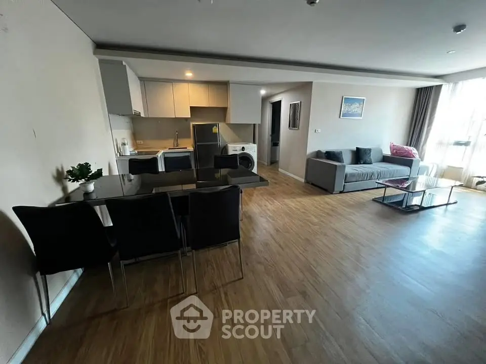 Spacious open-plan living room with modern kitchen and stylish decor