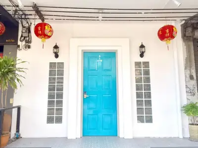 Charming entrance with vibrant blue door and decorative lanterns