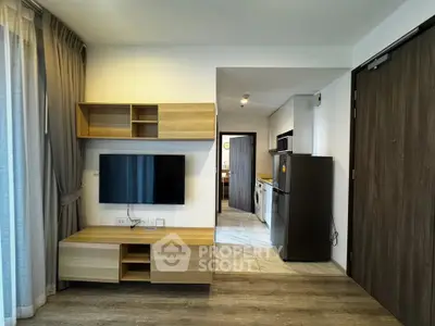 Modern living room with sleek wooden furniture and open kitchen layout in a stylish apartment.