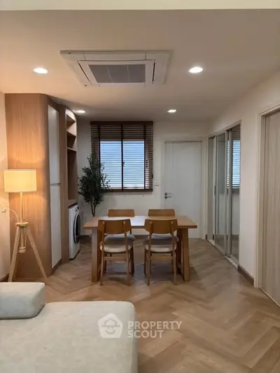 Modern living room with dining area and stylish wooden flooring