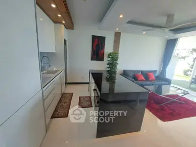 Modern open-plan living room with sleek kitchen and stylish decor