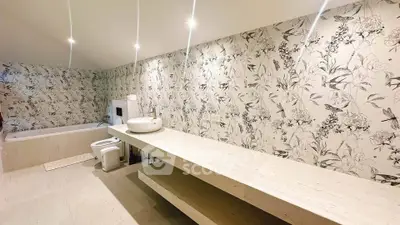 Luxurious bathroom with elegant floral wallpaper and modern fixtures