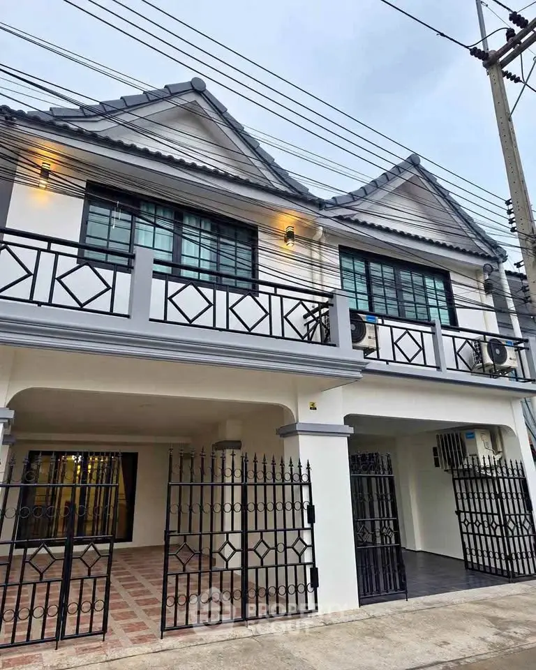 Charming two-story house with modern facade and spacious balcony in a serene neighborhood.