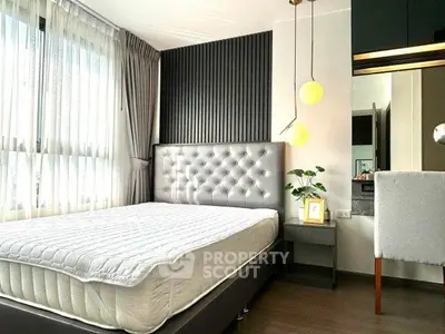 Modern bedroom with stylish decor and large windows for natural light