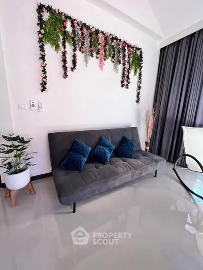 Stylish living room with modern sofa and floral wall decor
