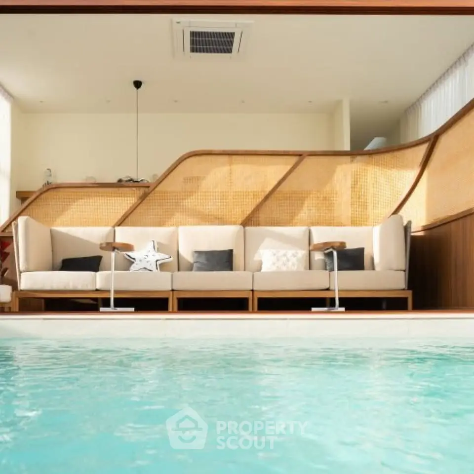 Luxurious indoor pool area with stylish seating and modern design