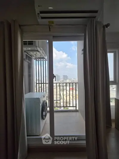 Modern apartment balcony with washing machine and city view, perfect for urban living.
