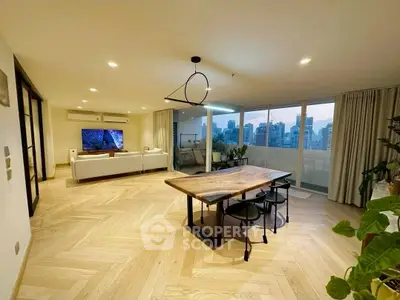 Spacious modern living room with city view, featuring elegant wooden flooring and stylish dining area.