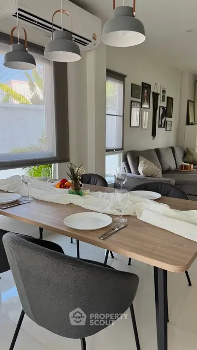 Modern dining area with stylish decor and natural light, perfect for entertaining guests.