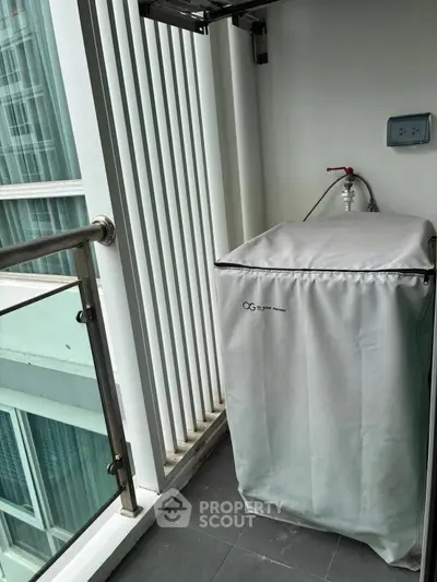 Modern balcony with washing machine and sleek railing in urban apartment