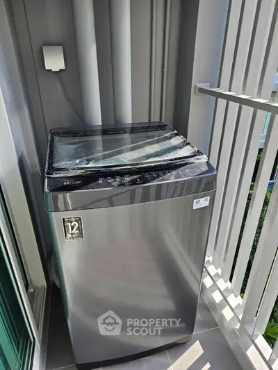 Modern washing machine on a balcony with sleek design and natural light