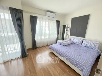 Spacious bedroom with large windows and modern decor