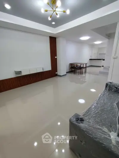 Spacious modern living room with sleek design and elegant lighting in a contemporary home.