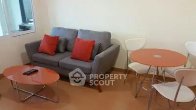 Cozy living room with modern sofa and stylish dining set, perfect for urban living.