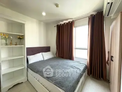 Cozy bedroom with modern decor and ample natural light, featuring a comfortable bed and stylish curtains.