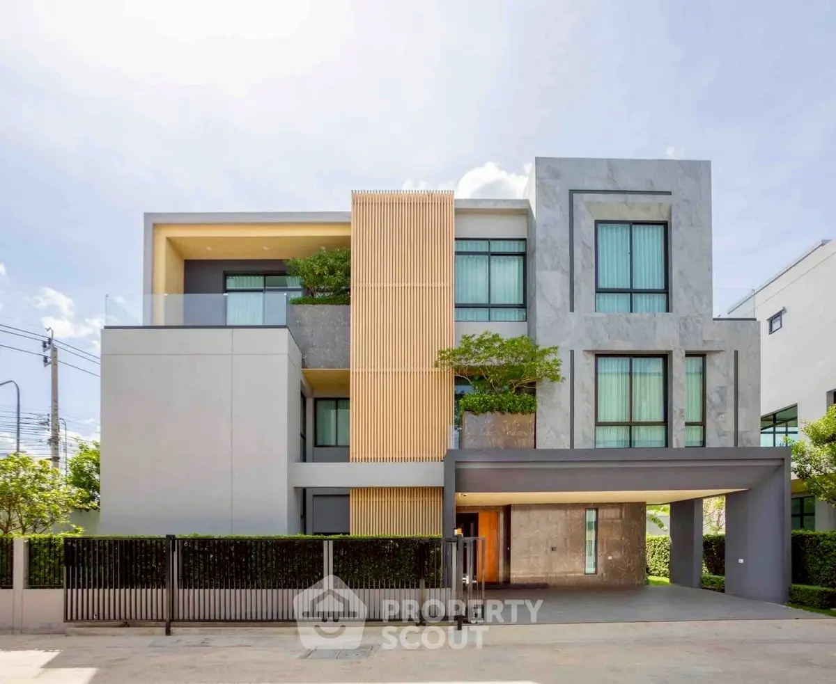 Modern luxury three-story house with sleek design and large windows in a serene neighborhood.