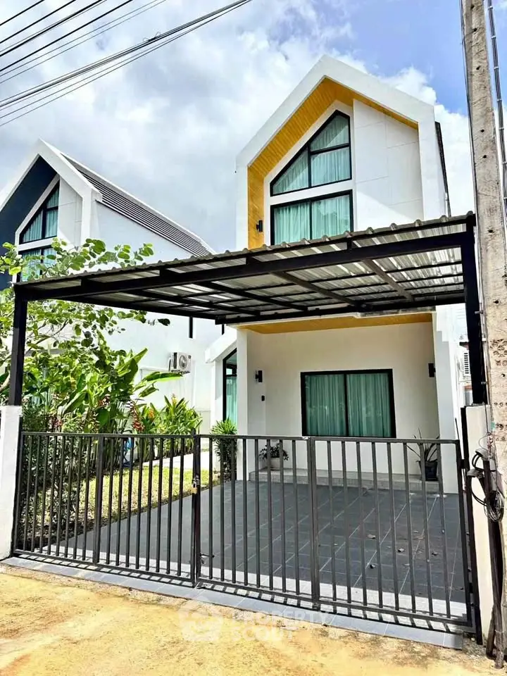 Modern two-story house with sleek design and gated driveway, perfect for contemporary living.