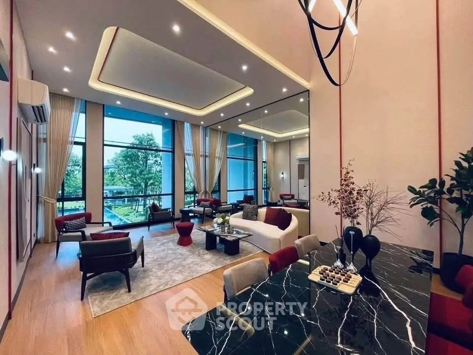 Luxurious modern living room with elegant decor and large windows offering a stunning garden view.
