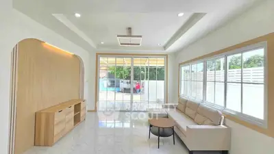 Spacious modern living room with large windows and elegant furniture