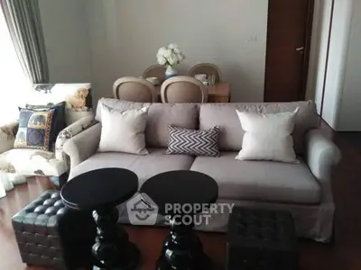 Charming living room with elegant sofa and stylish dining area in modern apartment.