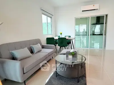 Modern living room with sleek furniture and dining area in open layout